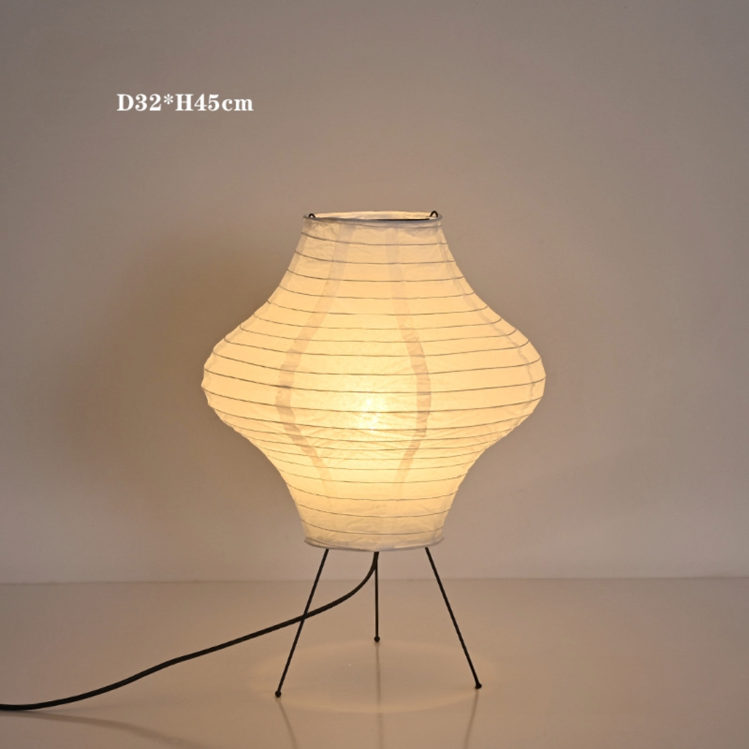 White paper desk lamp with diamond shape and tripod base.